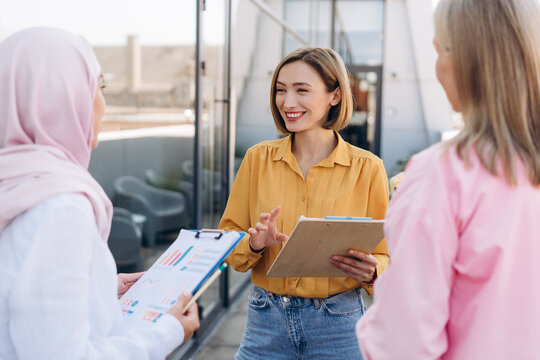 Diverse businesswomen discussing marketing reports during meeting