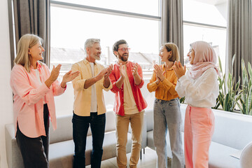 Diverse people clapping hands celebrating team success