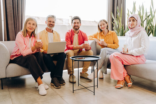Diverse business team smiling having coffee break
