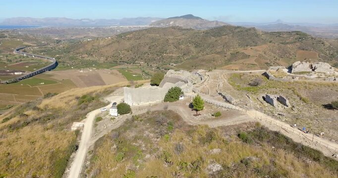 Aerial view of Segesta Theater. These are the ruins of a Greek theater located in the archaeological area, in the province of Trapani, Sicily, Italy. In the background is the Gulf of Castellammare.