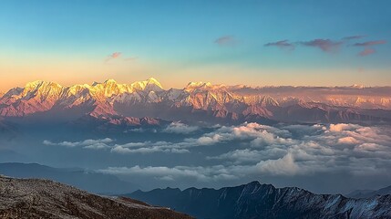 A breathtaking view of snow-capped mountain peaks bathed in golden sunlight, rising above a sea of fluffy clouds.