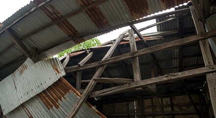 Decaying Barn Roof: Weathered Metal and Wooden Structure, Dramatic Perspective.