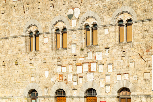 Massa Marittima building wall with historical coats of arms