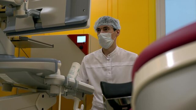Hospital doctor looks at the screen during sample analysis. Hospital doctor reading the analysis results. Hospital doctor examines the data after analysis of the patients body. Healthcare.