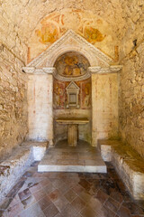 Ancient Romanesque sacellum with faded frescoes in Umbria, Italy