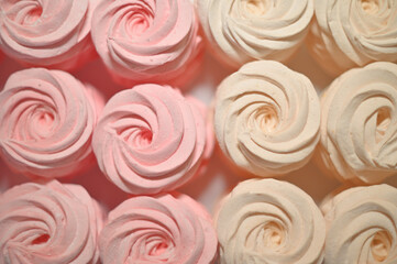 Beautiful background of hand-made marshmallows in pink and beige, color photo of food, sweets and treats