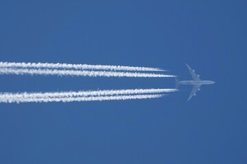 avion de ligne quadrimoteurs traces dans le ciel horizontales