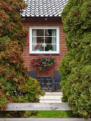 Cozy backyard of a private house with outdoor chairs and a table in autumn