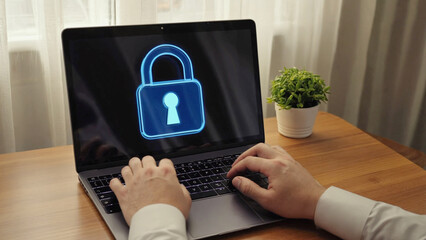 Cyber Fortress: A person's hands diligently operate a laptop, its screen prominently displaying a secure padlock icon, symbolizing robust data protection in the digital age.