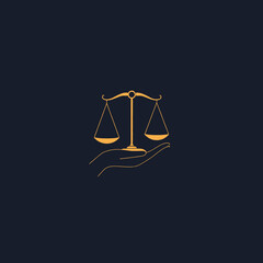 Golden scales of justice held delicately by a human hand, on dark background.