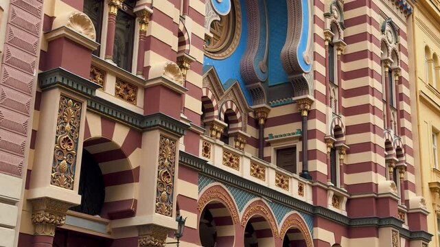 The opulent Neo-Moorish interior of the Spanish Synagogue in Prague, Czech Republic. Exquisite geometric patterns, vibrant colors, and elaborate gold ornamentation showcase 