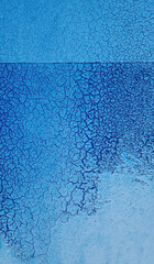 Grunge blue background with cracked paint. Old blue paint on the wall texture. Abstract background for design with copy space for text or image.
