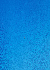 Grunge blue background with cracked paint. Old blue paint on the wall texture. Abstract background for design with copy space for text or image.