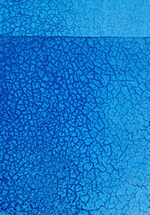 Grunge blue background with cracked paint. Old blue paint on the wall texture. Abstract background for design with copy space for text or image.