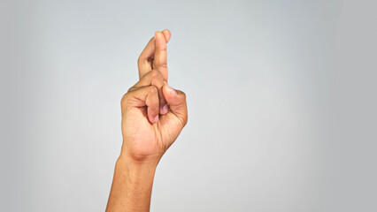 Hand Gesture Showing Good Luck Sign &mdash; Crossed Fingers Gesture on Studio Background
