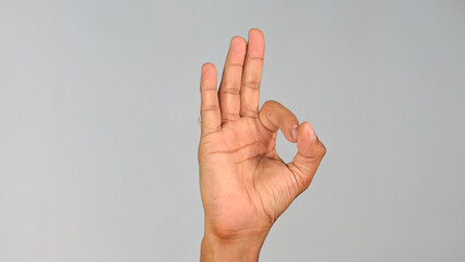 Naklejka premium Hand Gesture Showing OK Sign — Awesome Gesture on Studio Clean Background