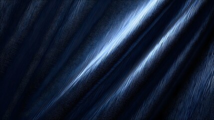 Fototapeta premium Rippled dark blue fabric texture with bright light highlights.