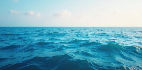 Obraz premium Vast, endless ocean expanse stretching to the horizon, calm waves gently rolling under a clear sky Perfect for travel, nature, and serenity themes , blue, natural
