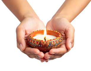 Two hands cradle a small, ornate oil lamp with a lit flame, isolated