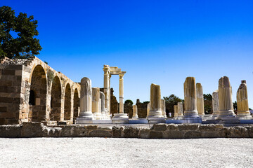 Exploring Ancient Ruins and Well-Preserved Columns Under a Clear Blue Sky in a Historic Archaeological Site