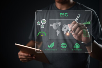 ESG concept. Man holding tablet analyze virtual dashboard. Corporate sustainability strategy,...