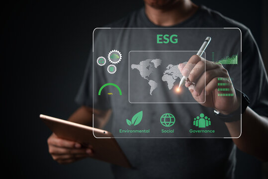 ESG concept. Man holding tablet analyze virtual dashboard. Corporate sustainability strategy, environmental social governance. Global data chart, green business development goal.