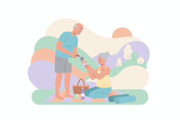 Happy senior couple enjoying a healthy outdoor picnic sharing drinks and companionship in nature