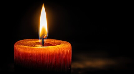 Close-up of Orange Candle with Bright Flame on Black Background, Ideal for Wallpaper, Poster and Ambiance Design, Showcasing Warm Glow and Intimate Vibe for Meditation, Holiday and Spiritual Rituals.