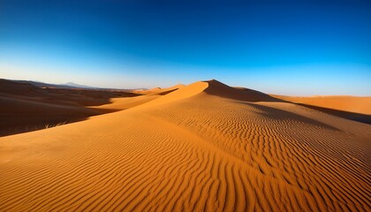 golden sand dunes under a clear blue sky desert landscape