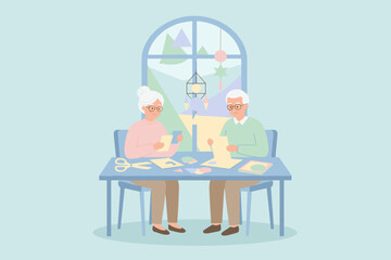 Happy elderly couple crafting together at home enjoying a creative hobby and quality time