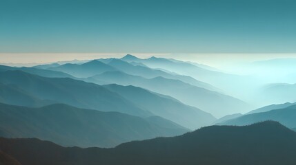 Fototapeta premium Layered mountain ranges fade into a hazy, atmospheric distance under a clear sky.
