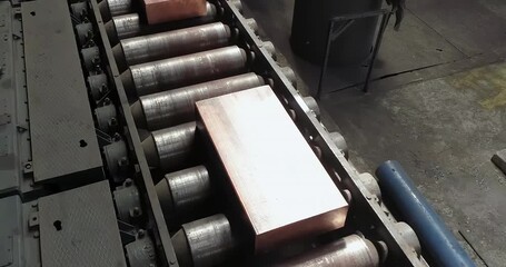 Aerial View of Metal Production Walking Type of Furnace Copper Bars at modern non ferrous color metal production plant. Industrial Conveyor. Metallurgy. Nonferrous metal manufacturing. Heavy industry. - Powered by Adobe