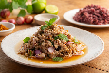 Spicy minced pork salad.ฺMixed boiled ground pork with red onion in chili lime sauce. (Laab Moo)