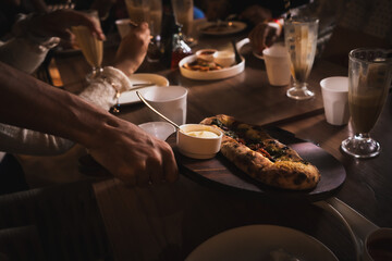waiter serving freshly baled food in Pizzeria