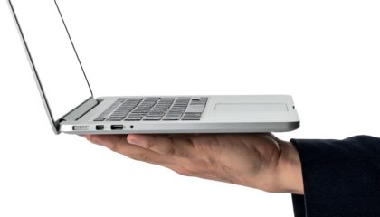 A hand supports a laptop, seen from the side with the screen open, against a black backdrop