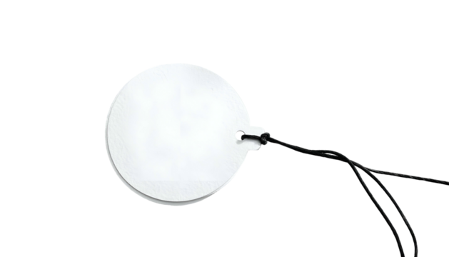 Round, white tag with a black string attached, isolated on a black background