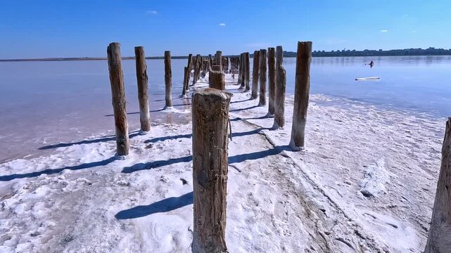 Sodium Chloride crystallized on the bottom and wooden poles