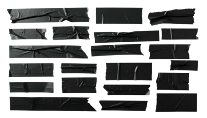Assortment of black adhesive strips, wrinkled and torn, against a black background