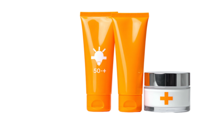 Bright orange sunscreen tubes and cream container set against a black background