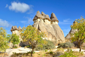 View of scenic geological formations and fairy chimneys in a beautiful valley with clouds, Cappadocia, Turkey