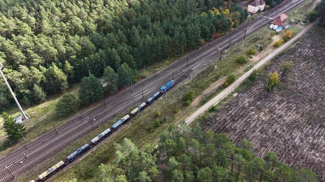 Aerial forest train railroad at spur transportation Poland. Northern Poland. Main transportation network for cargo and passengers in Europe. Trains are electric with overhead wires. Rural forest.
