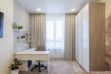 Bright room with a white desk, chair, window, and storage. Neutral color palette
