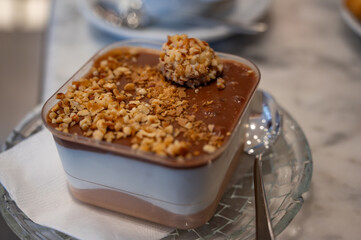 Chocolate nut soufflé with nut topping in a rectangular tray at a pastry shop