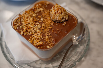 Chocolate nut soufflé with nut topping in a rectangular tray at a pastry shop