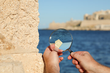 Archaeology in action: an expert studies an ancient relic with a magnifying glass, set against a...