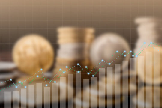 Financial investment concept with a rising stock market graph and bar chart overlayed on a blurred background of gold coins. Represents business growth, economic profit, savings, and wealth analysis.