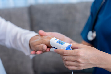 female hands in uniform with stethoscope is measuring pulse oximeter senior woman,healthcare worker or nurse physical examination old patient