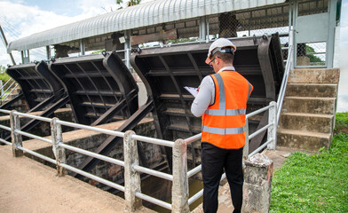Water gate Inspection dedicated engineer checking the flood barrier, dam engineer working on site