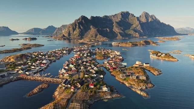 Henningsv&aelig;r - Lofoten's most famous fishing village in Norway. Aerial shot of Henningsvaer beautiful coastal village surrounded by mountains and calm waters in Norway