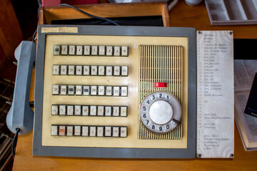 Retro Soviet factory intercom, a relic of bygone days. Dusty rotary phone, many buttons, embodying industrial decline and forgotten technology